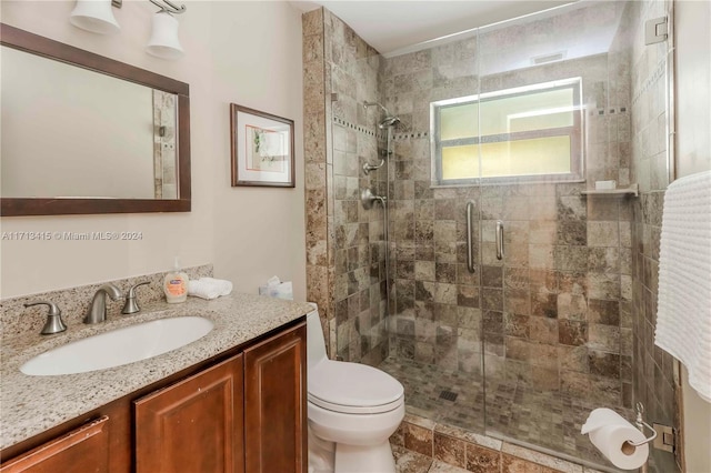 bathroom with toilet, vanity, and walk in shower