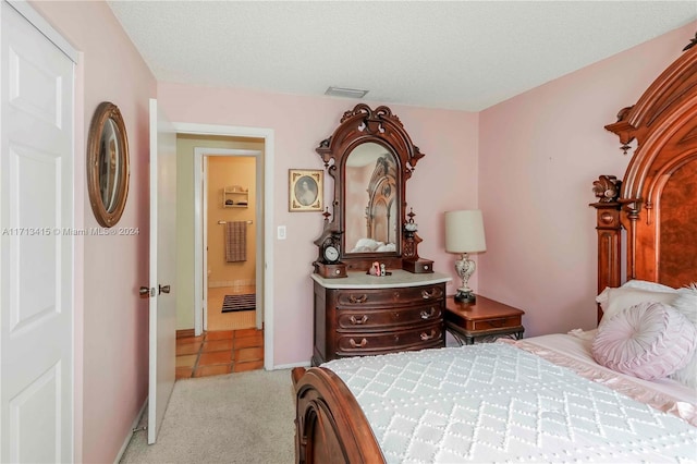 carpeted bedroom with a textured ceiling