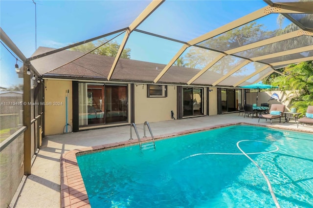 view of pool featuring a lanai and a patio area