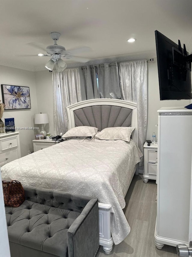 bedroom featuring light wood finished floors, ceiling fan, and recessed lighting