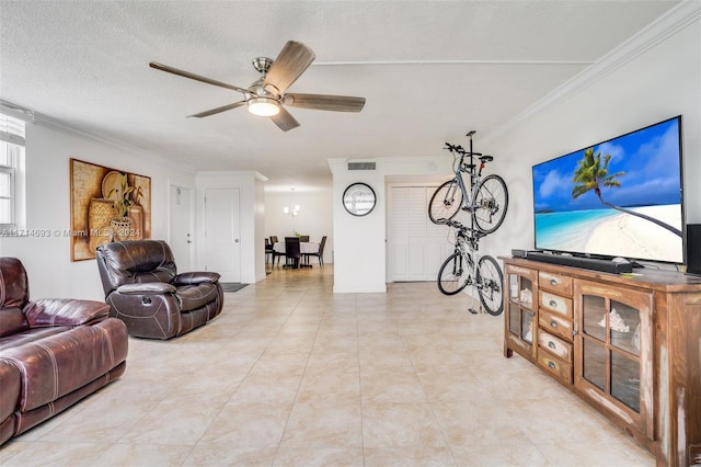 living room featuring a textured ceiling, ceiling fan, and crown molding