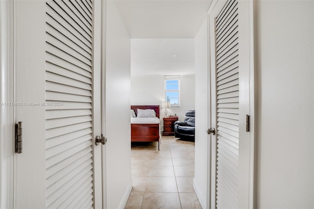 hall with light tile patterned floors