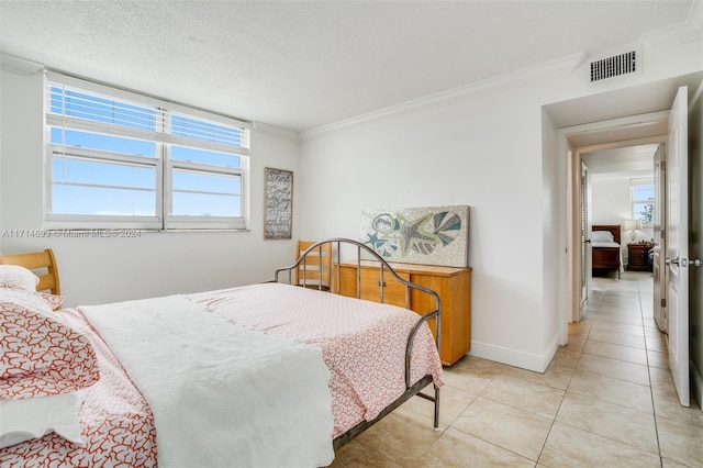 tiled bedroom with a textured ceiling and ornamental molding