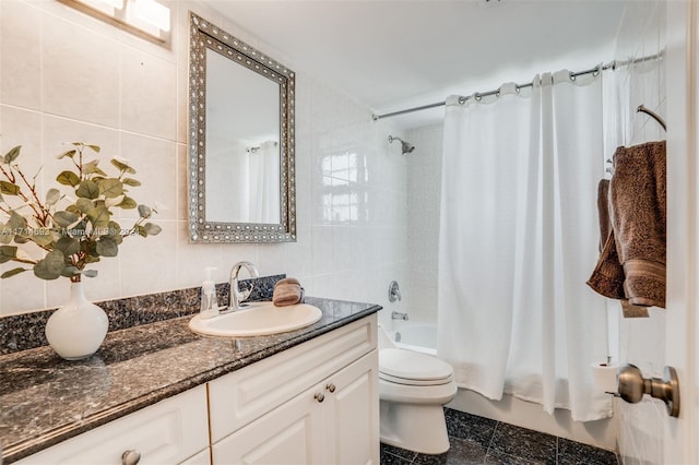 full bathroom with vanity, toilet, shower / bath combo with shower curtain, and tile walls