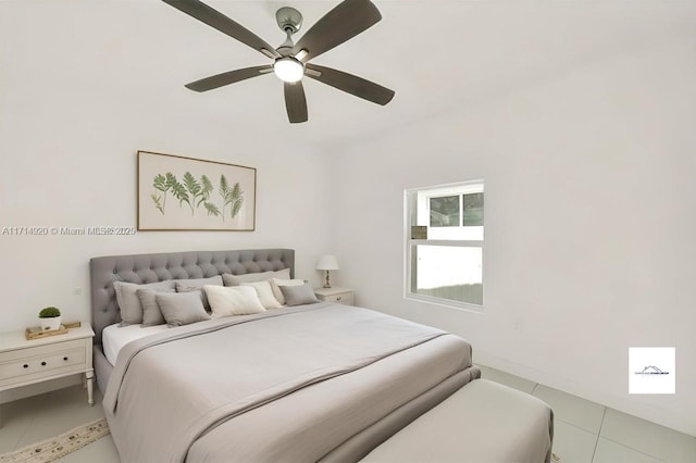 tiled bedroom featuring ceiling fan