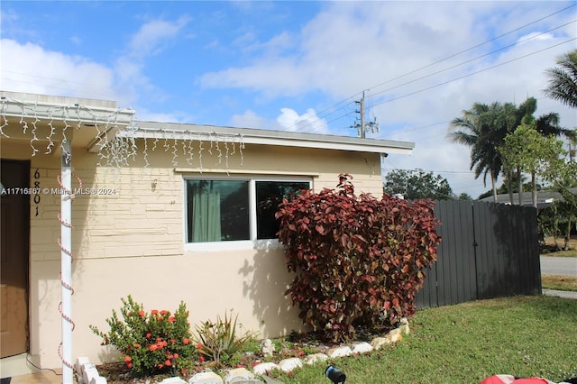 view of property exterior featuring fence and stucco siding