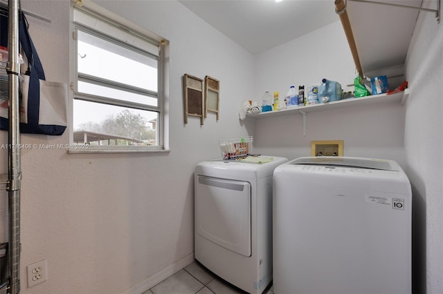 washroom featuring washing machine and dryer and light tile patterned floors