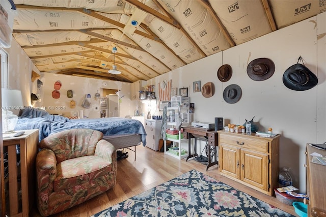 bedroom with light hardwood / wood-style flooring and vaulted ceiling