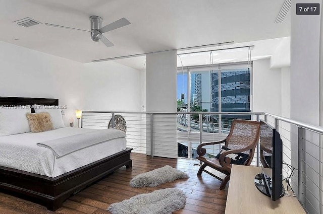 bedroom featuring a ceiling fan, visible vents, and hardwood / wood-style flooring