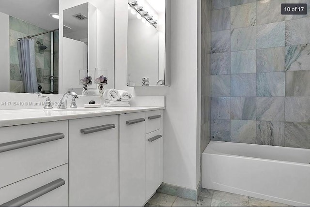 bathroom with shower / bath combo, vanity, and baseboards