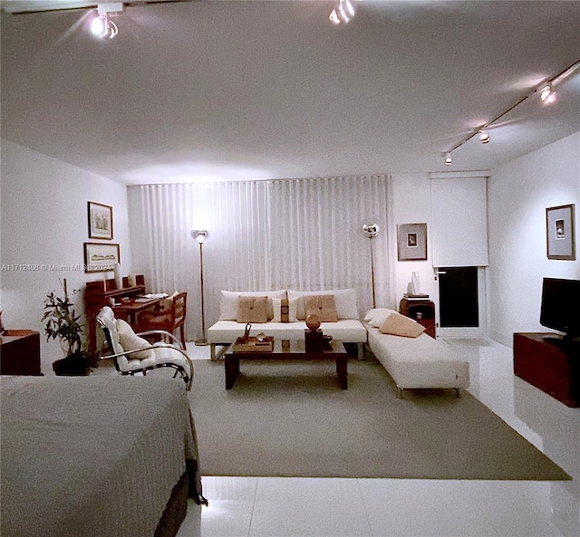 interior space featuring ceiling fan and rail lighting