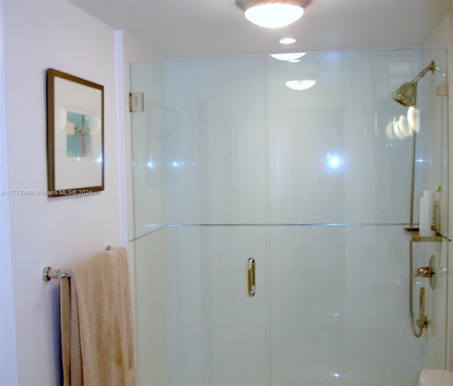 bathroom featuring a shower with door