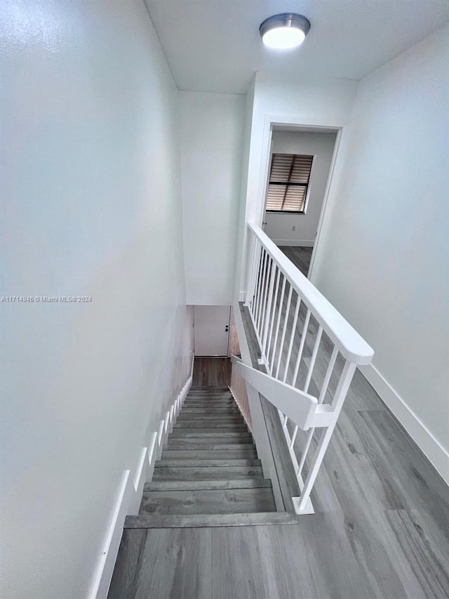 stairs with wood-type flooring