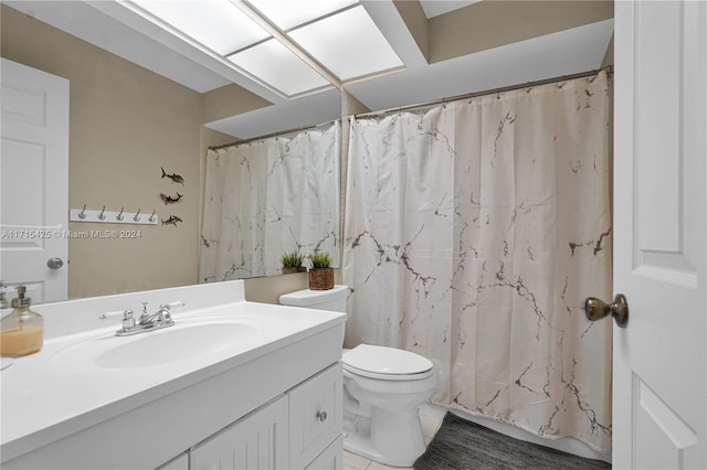 bathroom featuring tile patterned flooring, vanity, a shower with shower curtain, and toilet