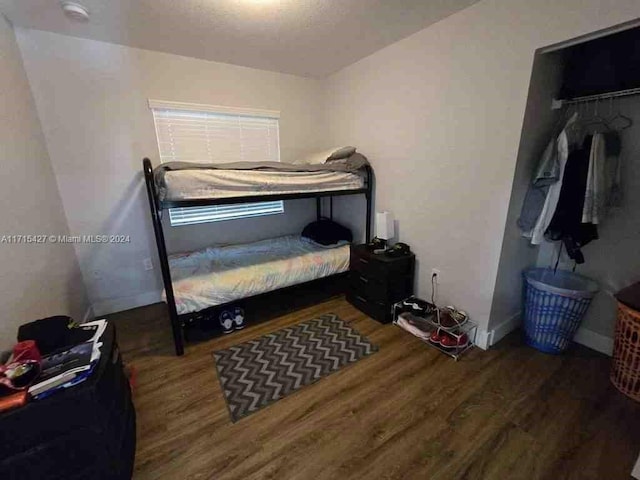 bedroom featuring a closet and dark hardwood / wood-style floors