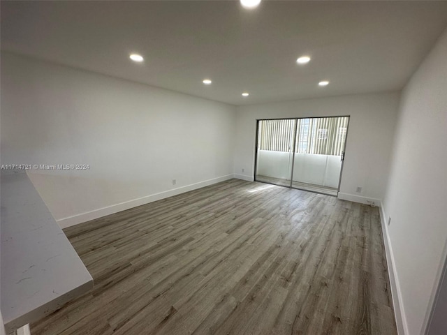 spare room featuring wood-type flooring