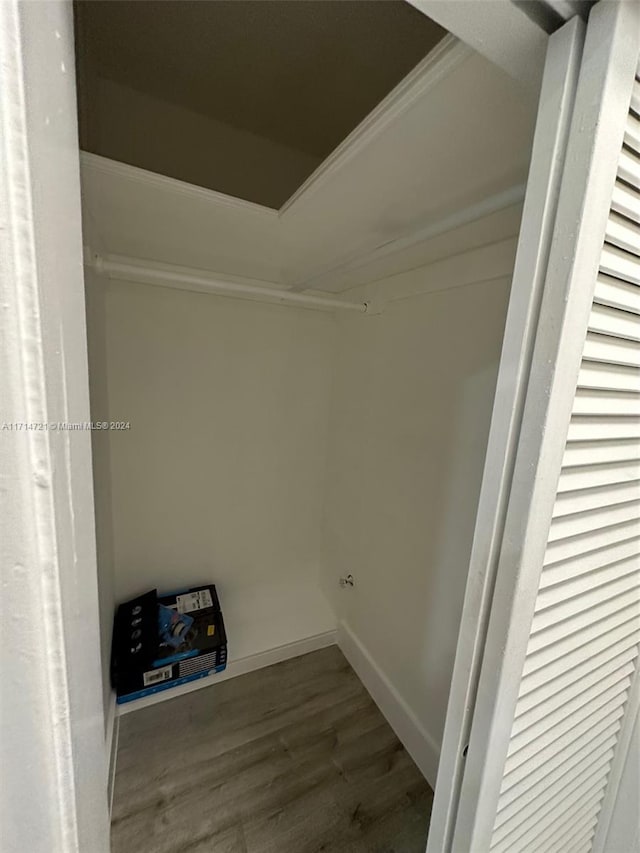 clothes washing area featuring wood-type flooring