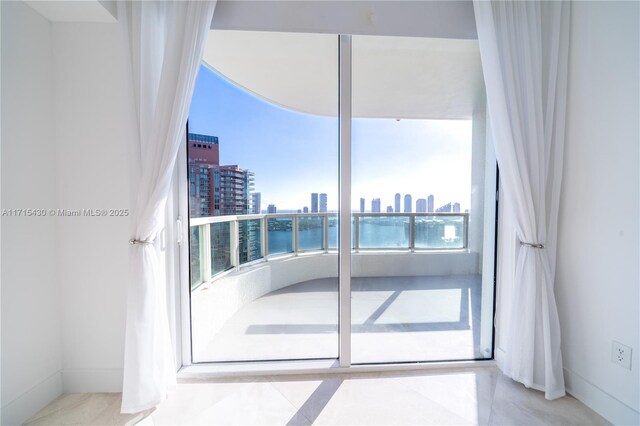 bedroom with a wall of windows and access to outside