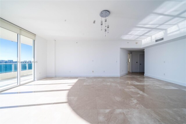 unfurnished room featuring floor to ceiling windows