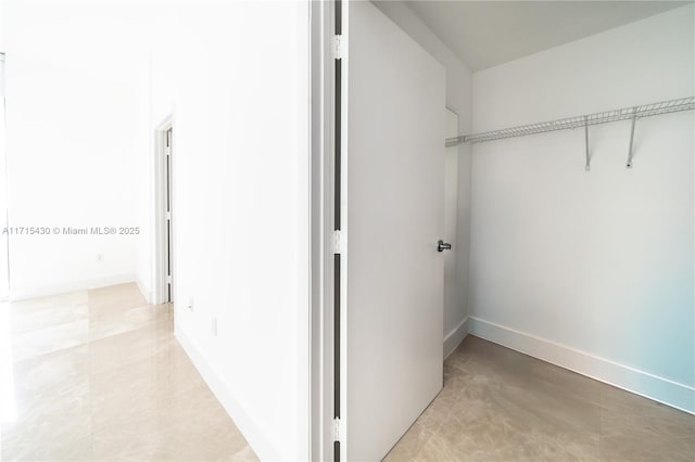 laundry area featuring baseboards