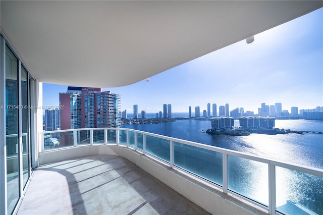 balcony featuring a water view and a view of city