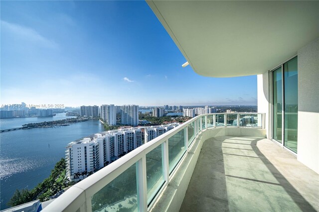 view of pool featuring a water view and a patio