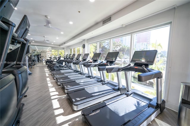 gym with dark wood-style floors, visible vents, and recessed lighting