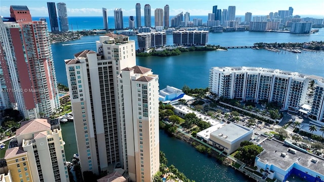 birds eye view of property featuring a water view and a city view