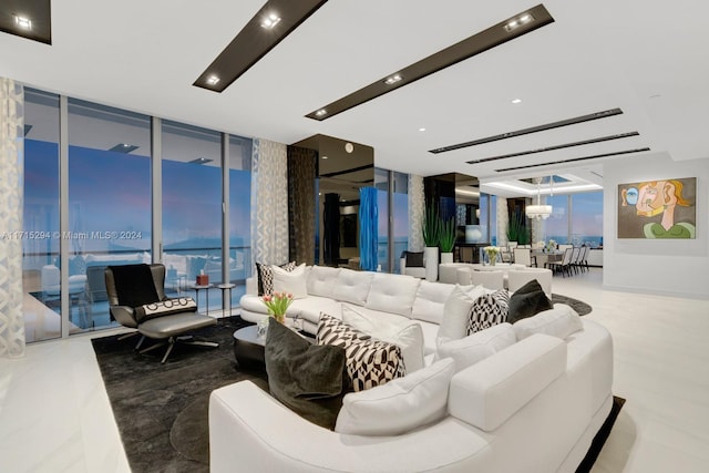 living room with expansive windows and a chandelier