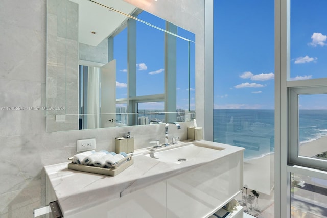 bathroom featuring vanity, a water view, and a wealth of natural light