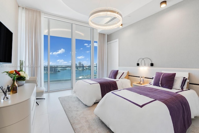 bedroom with access to outside, a water view, light tile patterned flooring, and a wall of windows