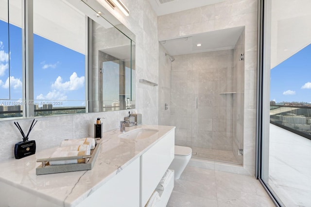 bathroom with tile walls, plenty of natural light, vanity, and an enclosed shower