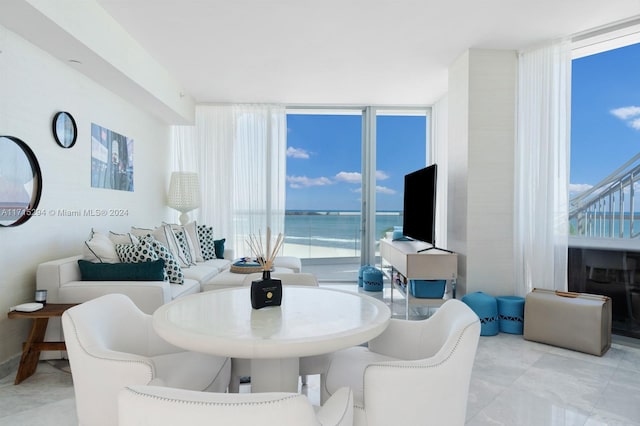 dining room featuring a healthy amount of sunlight and a wall of windows