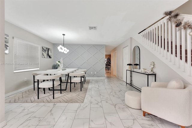 dining area with an inviting chandelier