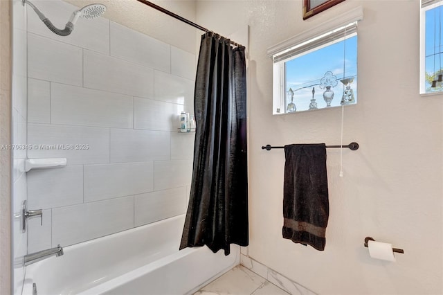 full bathroom with shower / bath combination with curtain and marble finish floor