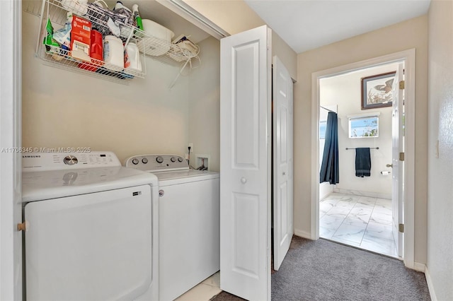 washroom featuring baseboards, laundry area, light carpet, washing machine and dryer, and marble finish floor