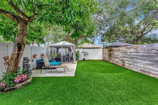 view of yard with a gazebo, a patio area, and a fenced backyard