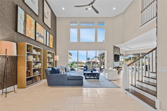 living room featuring a high ceiling and ceiling fan