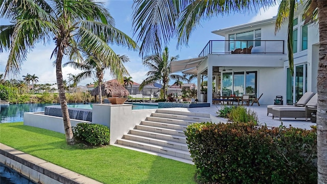 view of pool featuring a patio, a water view, and a yard