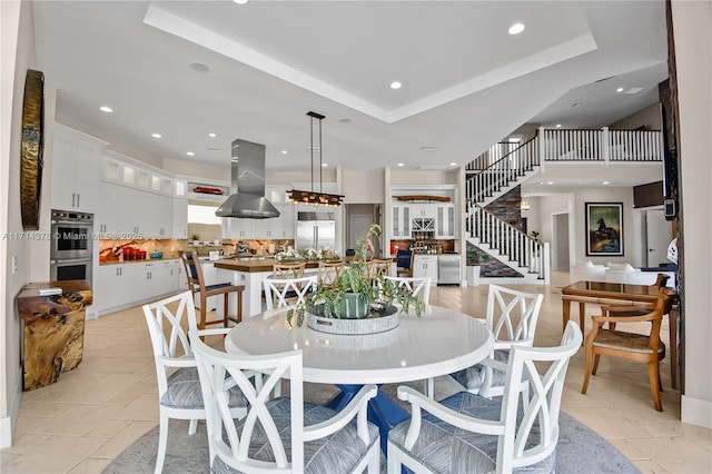 dining space featuring a raised ceiling