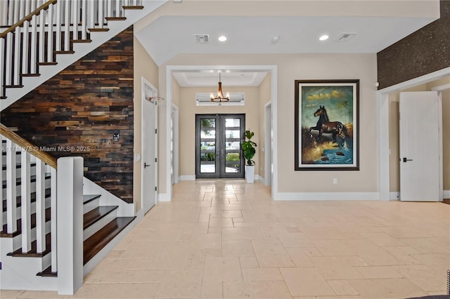 entrance foyer featuring french doors and a chandelier