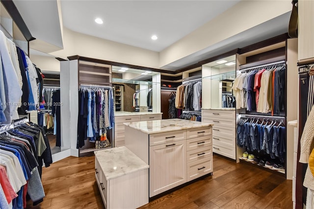 walk in closet with dark wood-type flooring