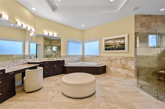 bathroom featuring vanity, separate shower and tub, and tile walls