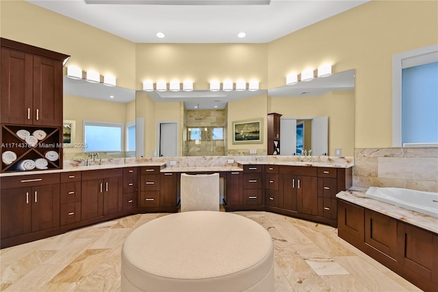 bathroom featuring shower with separate bathtub and vanity