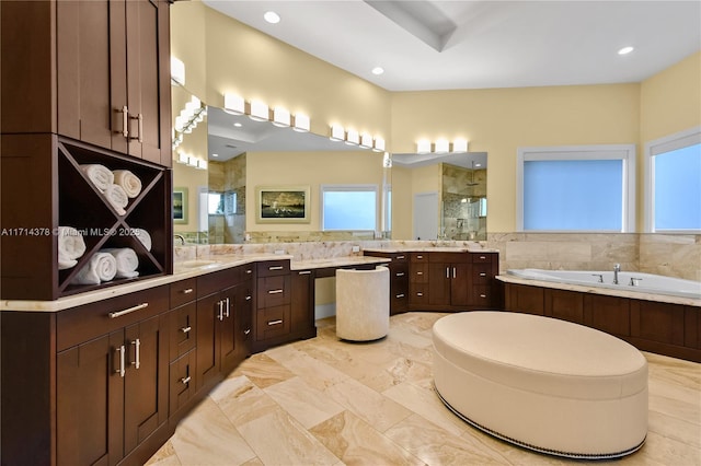 bathroom with vanity and independent shower and bath