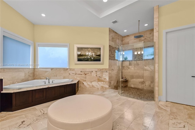 bathroom featuring separate shower and tub and tile walls