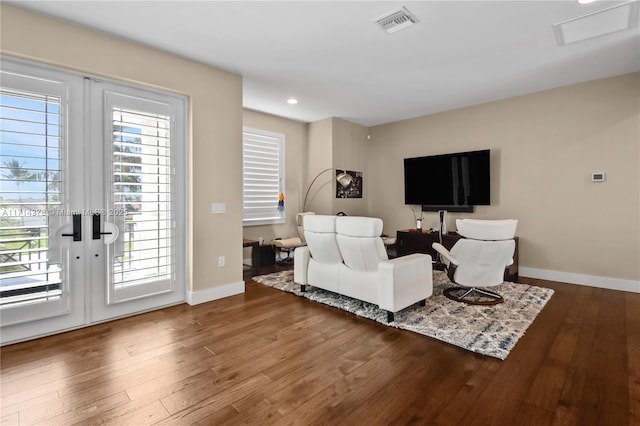 living room featuring hardwood / wood-style flooring, plenty of natural light, and french doors