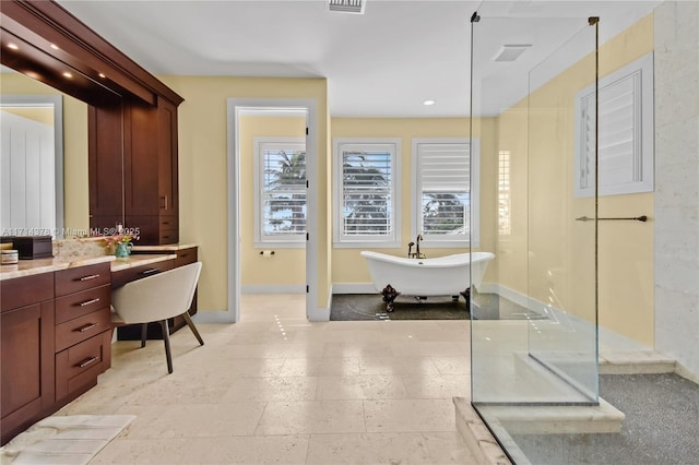 bathroom with vanity and independent shower and bath