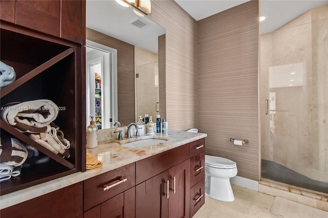 bathroom featuring vanity, toilet, and a shower with shower door