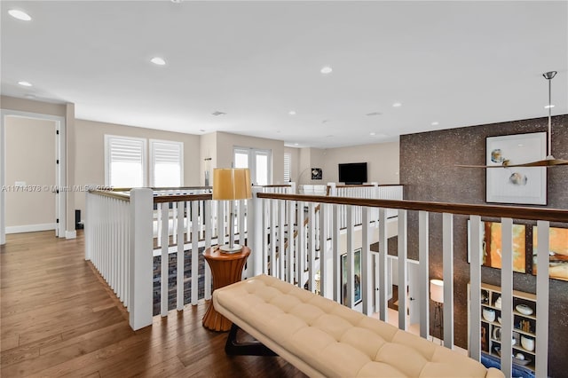 hallway with hardwood / wood-style floors